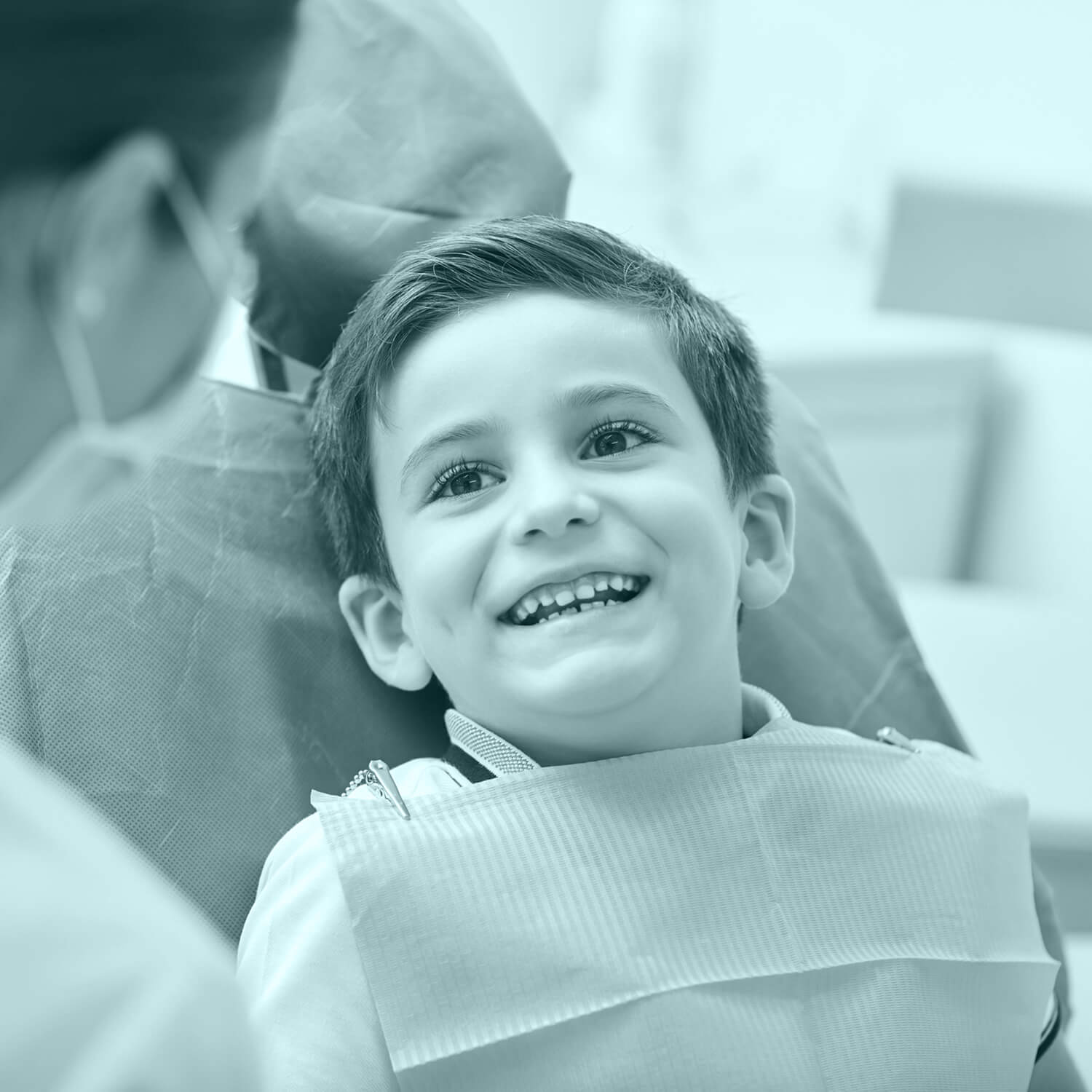 kid at the dentist chair smiling