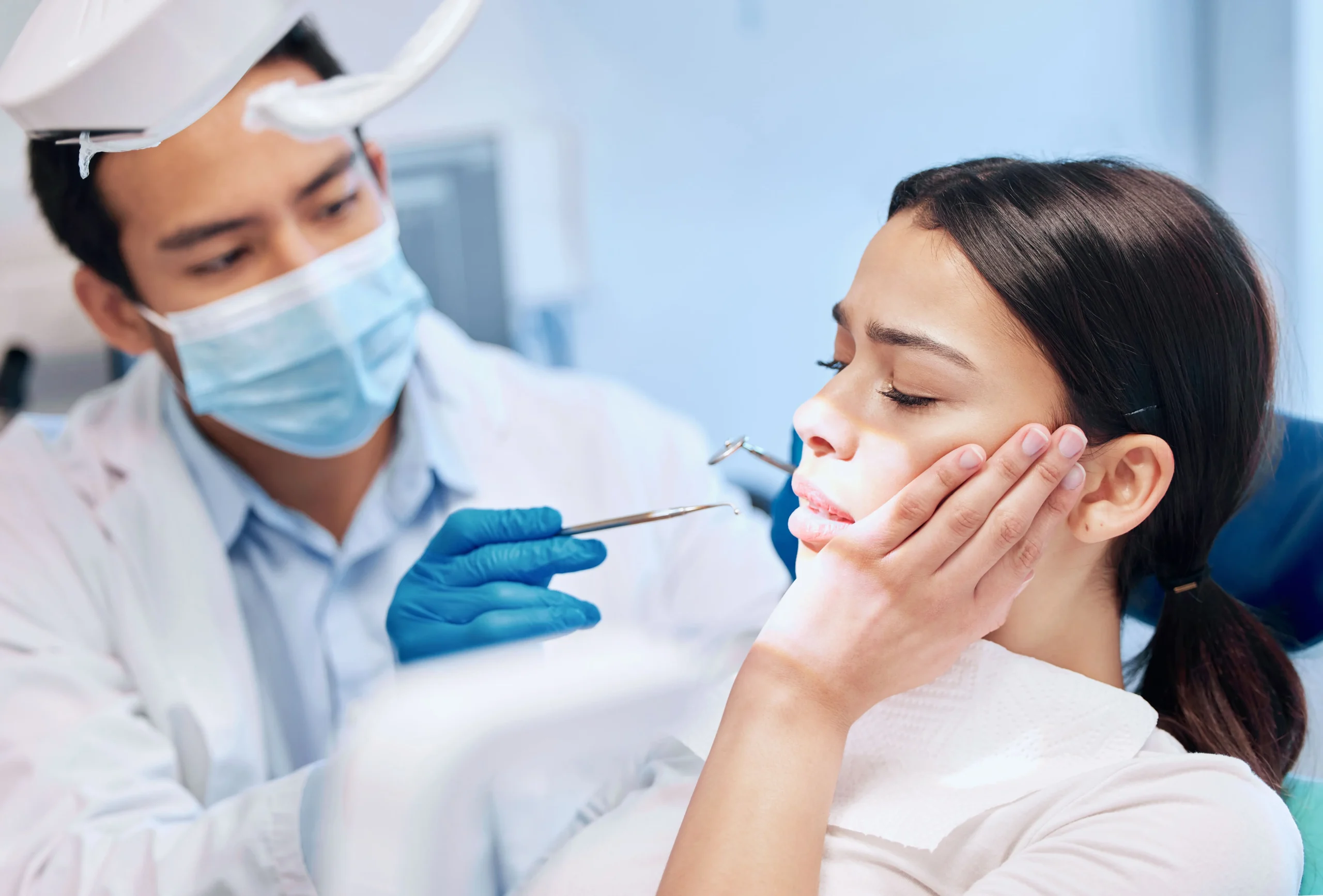 A woman at the dentist for tooth extraction
